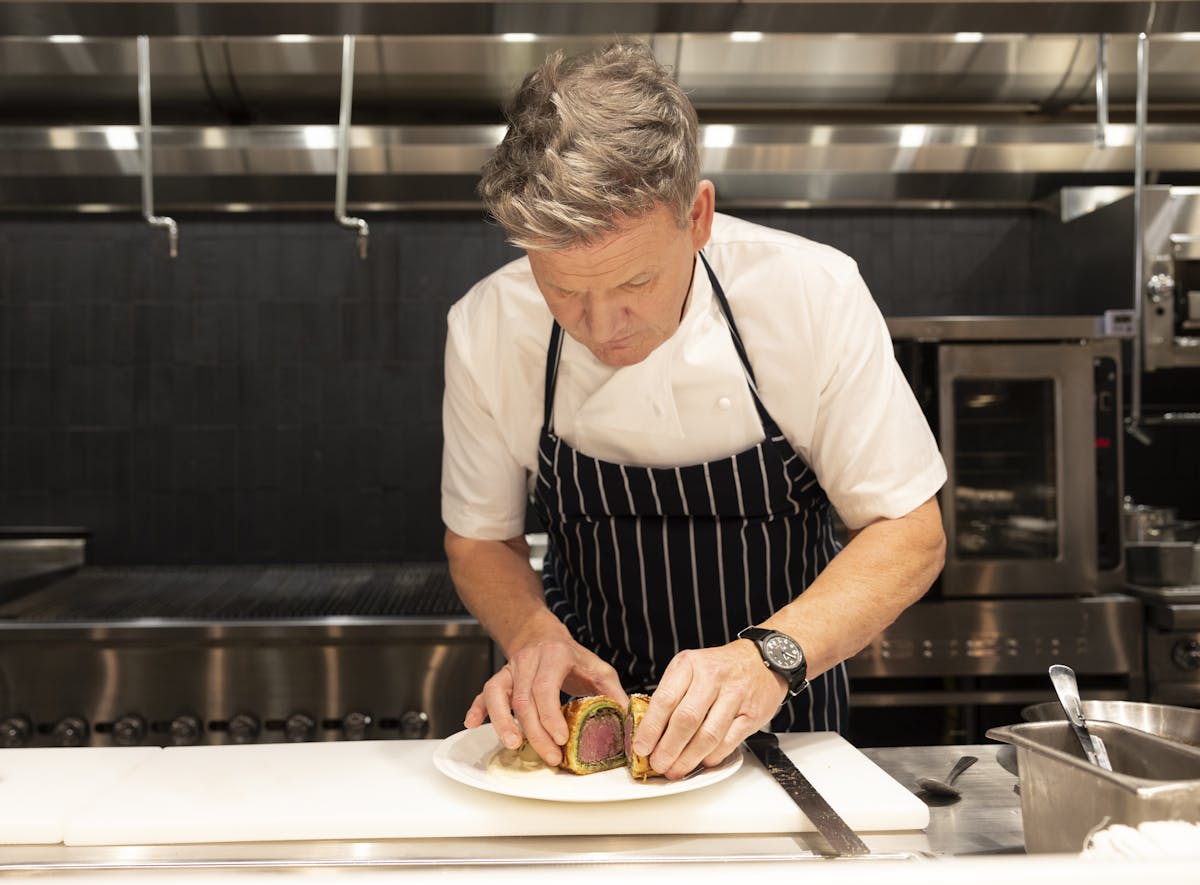 a man cooking in a kitchen preparing food